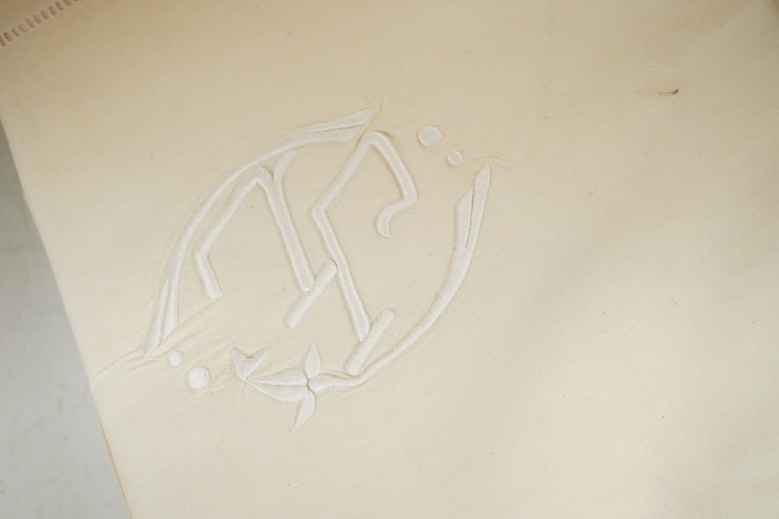 Seven French provincial coarse linen sheets, with a drawn thread bordered large white monogrammed turn backs